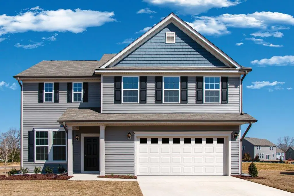 A two-storey home with a white garage door
