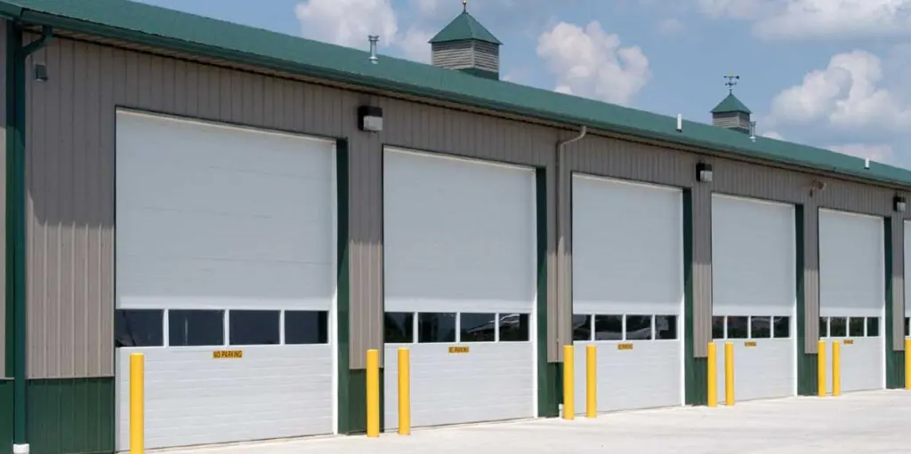 A row of commercial sectional doors on a steel building