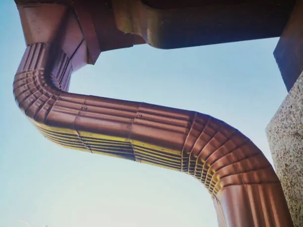 A curved downspout coming off a gutter