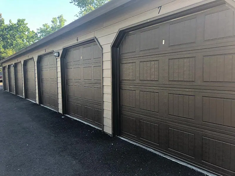 A row of new dark brown garage doors installed by O’Neill’s