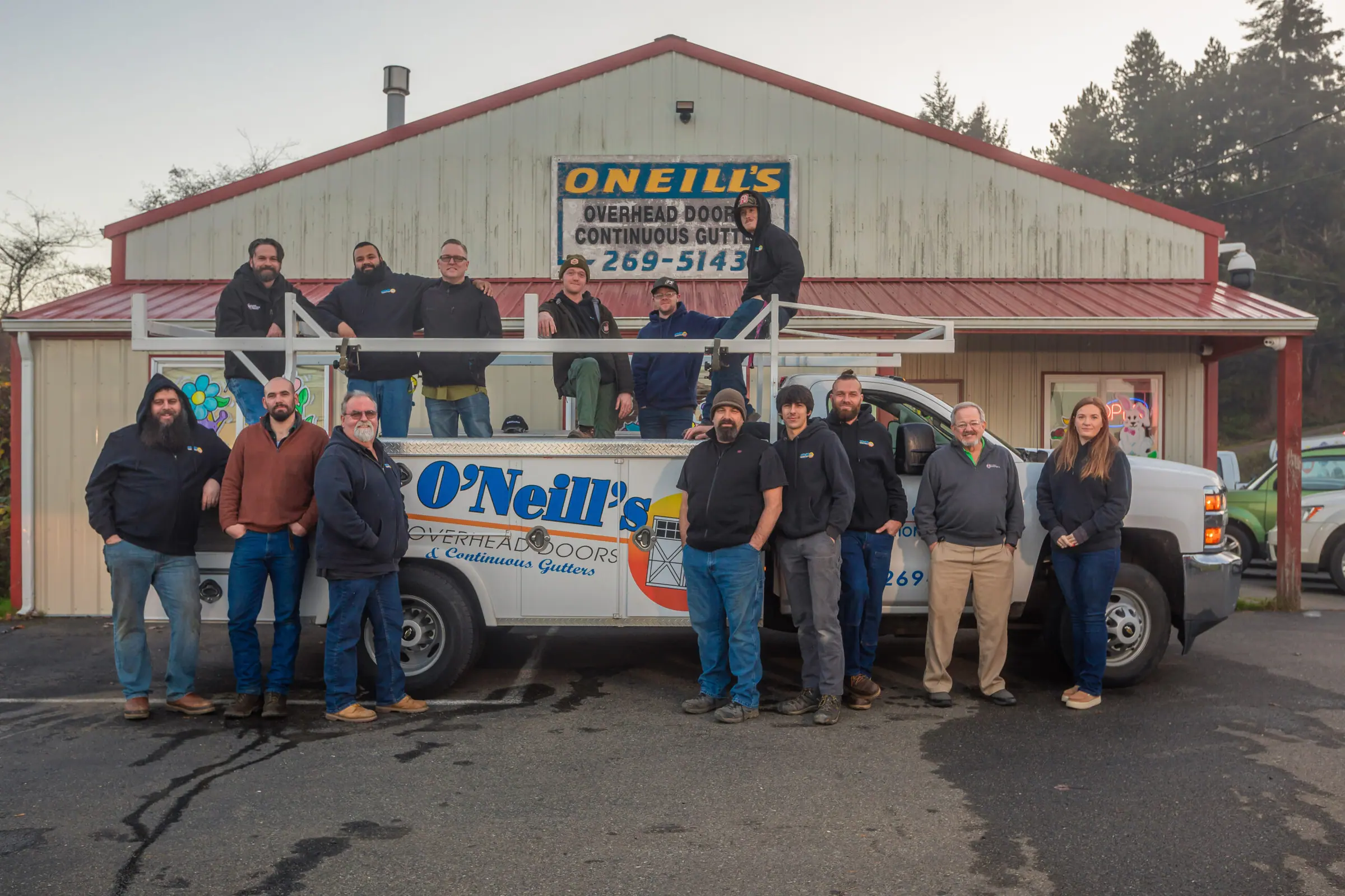 The O'Neill's crew in front of the shop and an O'Neill's service truck in Coos Bay