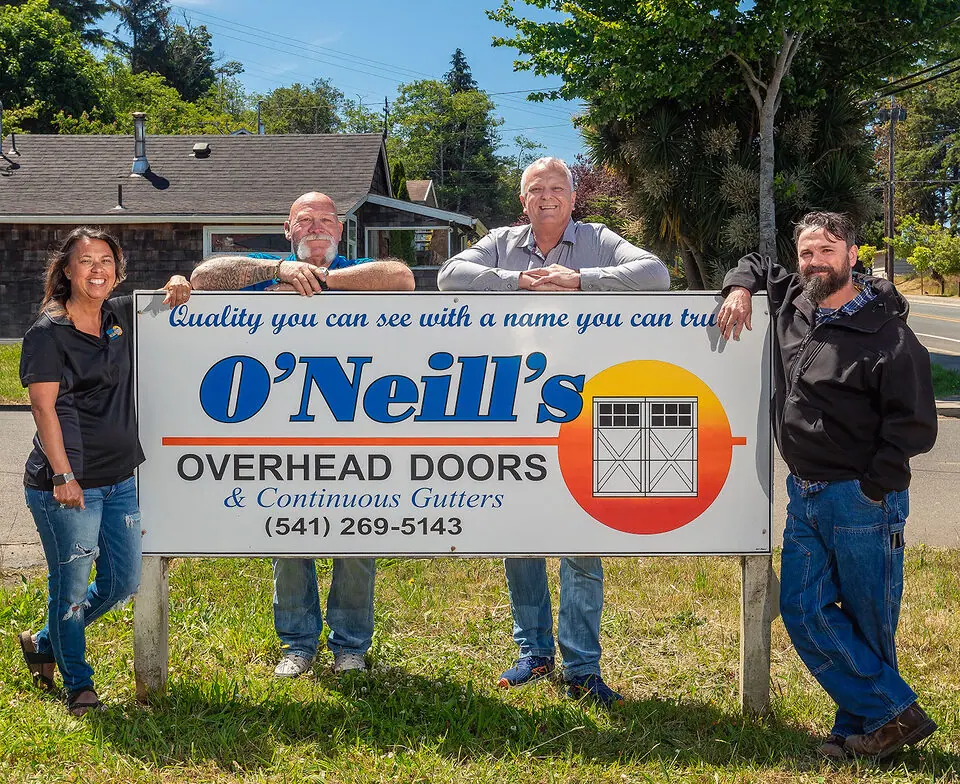 The O’Neill’s team at the company sign in Coos Bay