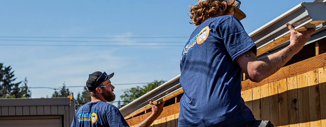 Two O'Neill's installers working at a roof edge