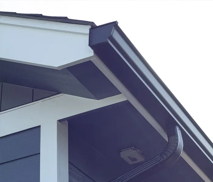 White seamless gutters along the roofline of a home