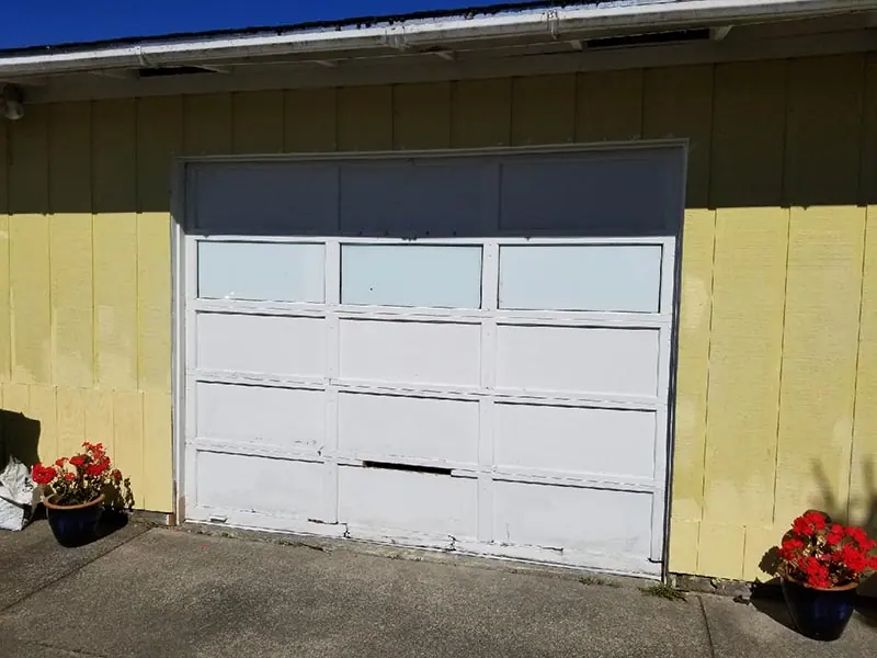 Before: Damaged single door with windows replaced