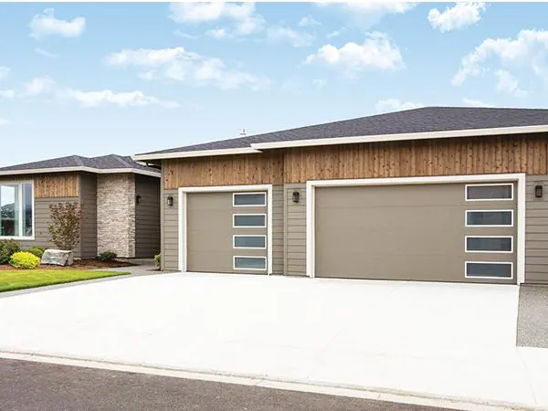 Modern flush steel garage doors on a contemporary home